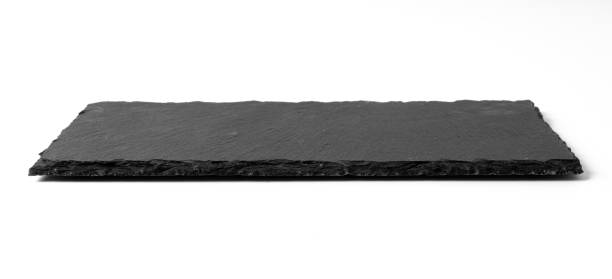 istock Black stone plate isolated on white background 1183705733