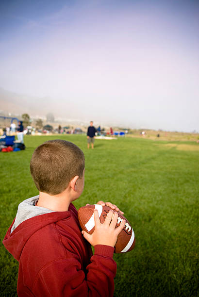 istock Young Boy Playing Football with Copy Space 118370811