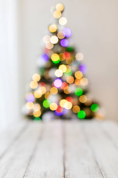 istock Merry Christmas! White candlestick flashlight stands on the background beautiful blurred christmas tree with luminous garland. 1183709676