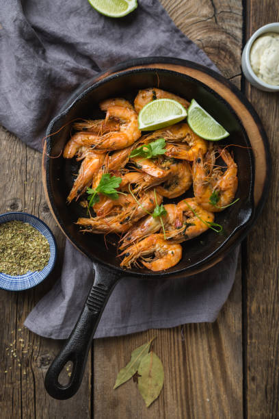 istock Fried prawns with lime in a pan 1183710300