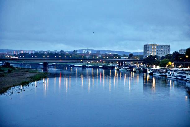 istock Bridge Over River By Buildings Against Sky In City 1183713400