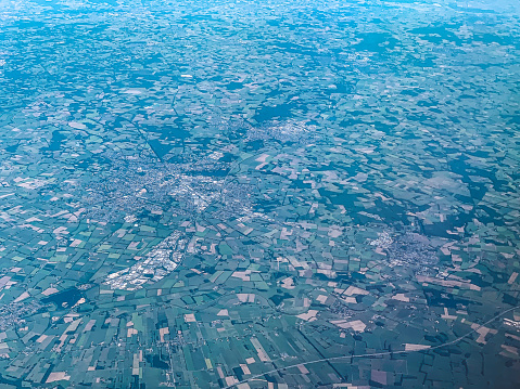 Sweeping panoramic view of the green and vibrant English countryside.  Farmland, rivers and villages pepper this impressive and unique landscape.  Hazy horizons and glorious greens in this summer scenic.  Stitched panorama.  