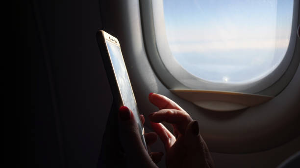 istock Woman on the plane working with a smartphone . 1183715799