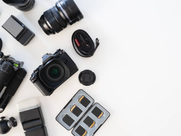 istock top view of work space photographer with digital camera, flash, cleaning kit, memory card, tripod and camera accessory on white table background 1183715844