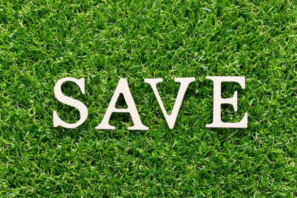 istock Wood alphabet in word save on artificial green grass background 1183715871