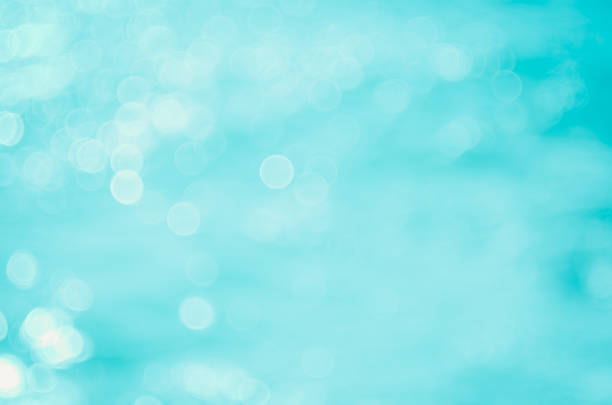 Copy space blur tropical beach with bokeh sun light wave on blue sky and white cloud abstract background. Summer vacation outdoor and travel holiday adventure concept. Vintage tone filter effect color.