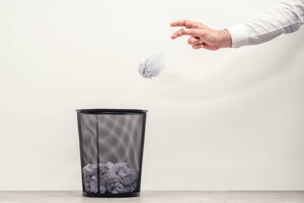 businessman throwing waste paper to trash can in office - paper crumpled document garbage imagens e fotografias de stock