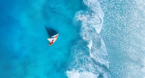 istock Wave and boat on the beach as a background. 
Beach and waves from top view. Turquoise water background from top view. Top view from drone. Travel - image 1183720201