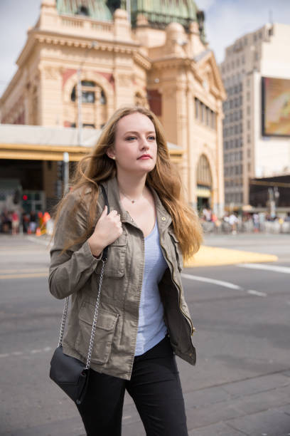 istock Young Woman Walking in Downtown Melbourne 1183720217