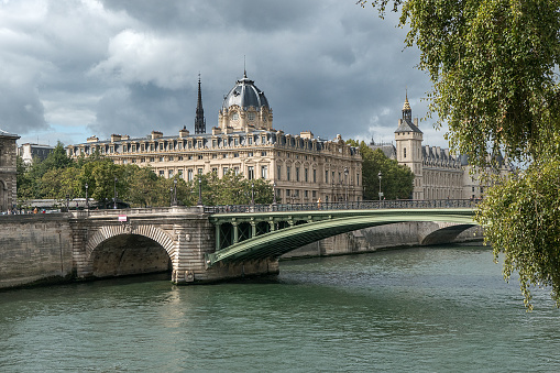 Characteristic Parisian architecture along the Seine river, Paris France. In front the Pont Notre Dame. In the background Palais de Justice de Paris and Greffe du Tribunal de Commerce de Paris