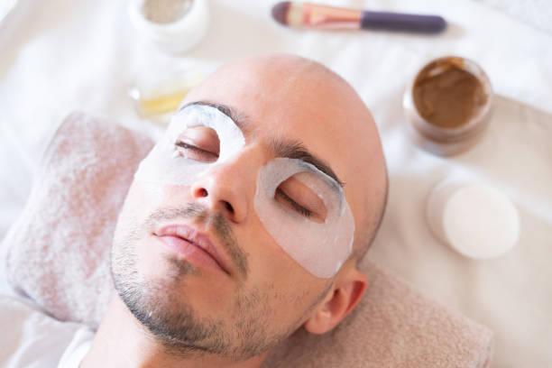 istock Man with moisturizing mask for skin around the eyes. 1183723175