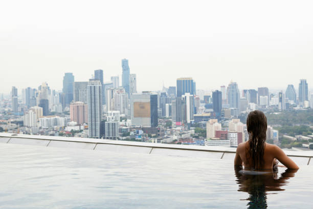istock Woman relaxing on a rooftop pool 1183725214