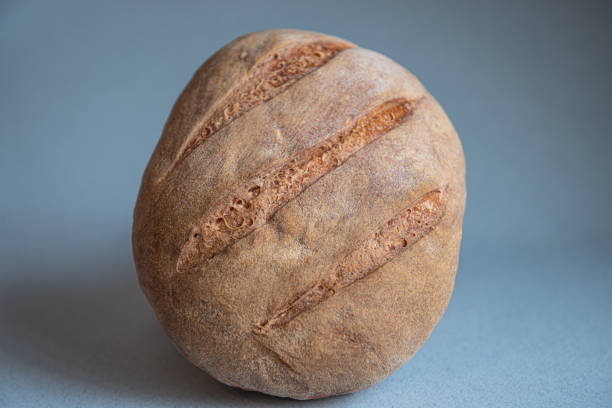 istock freshly baked bread isolated on blue background 1183726248