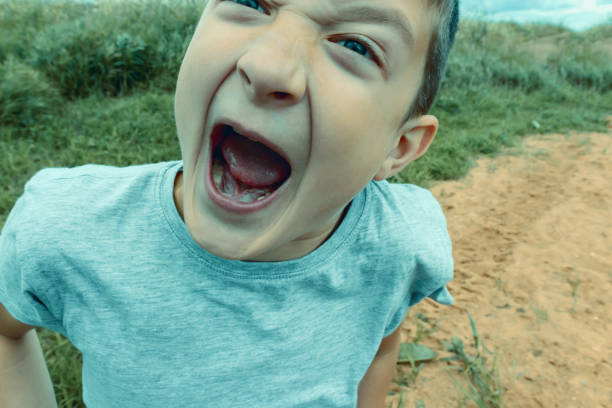 istock Angry screaming teenage boy with open mouth close up, deviant behavior concept 1183727761
