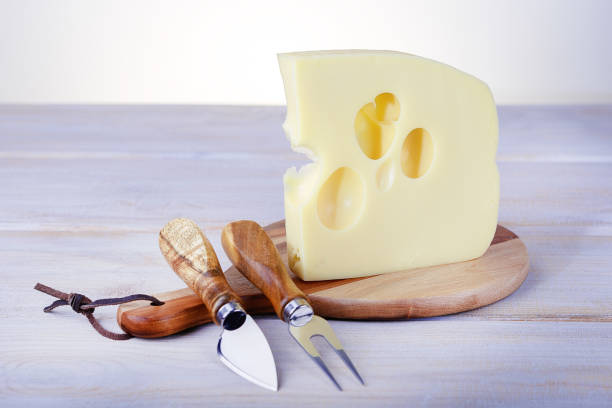 istock Maasdam or cheddar cheese on cutting board. 1183728559