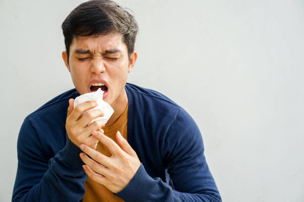 istock close up young asian man sneezing after get allergy or flu virus and using tissue paper for swipe on nose at medical clinic after hard working for unhealthy lifestyle concept 1183729196