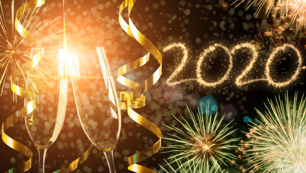 istock 2020 New Year fireworks with sparkling wine in the foreground 1183729426