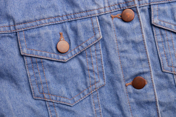 istock Blue jeans texture with pocket and buttons as background with place for text. Top view and macro view of jeans jacket 1183731604