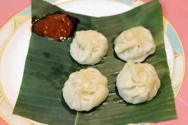 Kadubu or Steamed sweet momo one of the healthy and traditional recipe favorite of God Lord Ganesha served with Sweet Chili Sauce