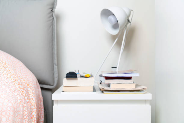 istock Bedside table with books and a lamp 1183734168
