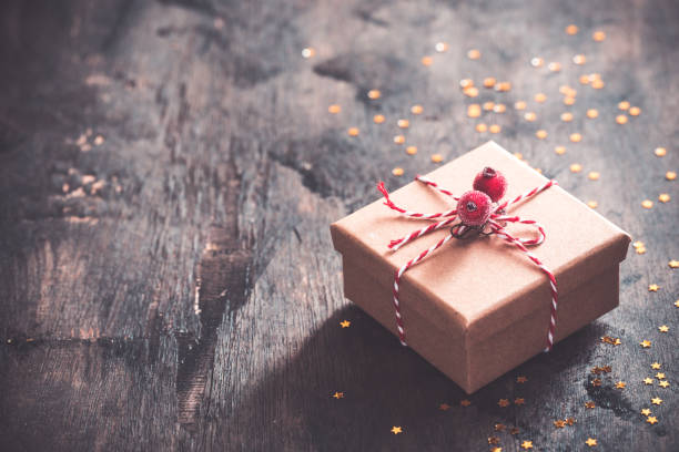 istock gift box with red bow on wooden table with copy space, christmas background 1183735862