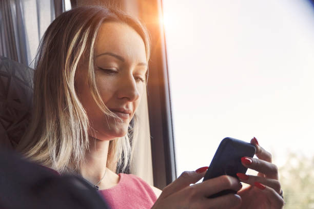istock Woman using mobile phone on her bus trip 1183737038