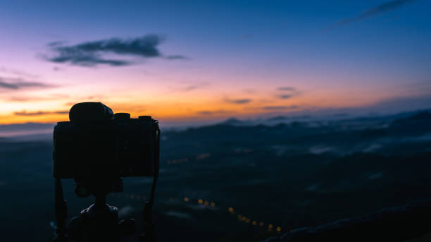 istock Morning Sunlight and camera on tripod 1183737936