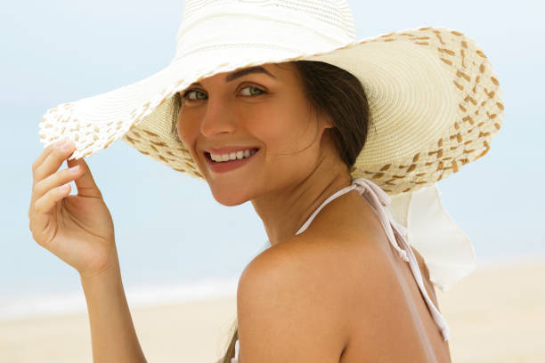 istock Beautiful woman in beach hat 1183739860