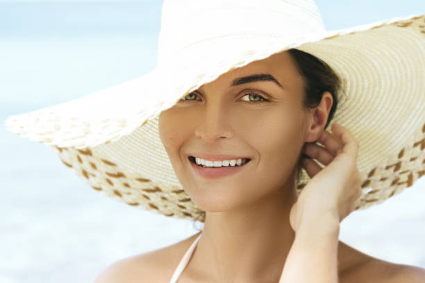 istock Pretty and young woman in beach hat 1183740170