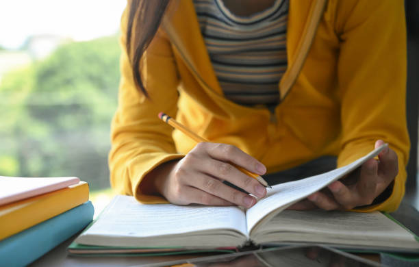 istock Students are reading books and taking notes for exam preparation. 1183741030