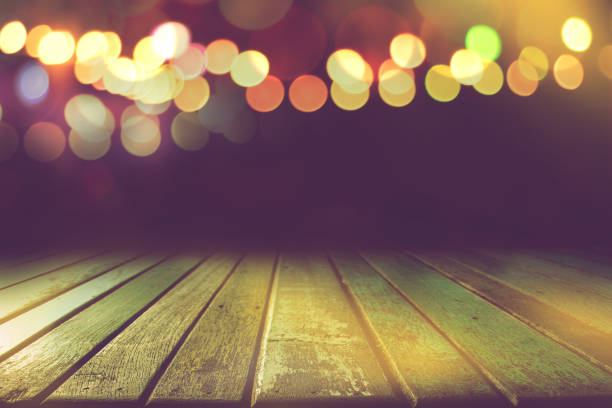 istock empty colour wooden table with bokeh light in dark night background 1183742851