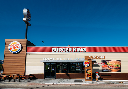 Madrid, Spain - Oct 26, 2019: Outside a fast-food Burger King restaurant with a sleek, contemporary futuristic industrial look includes brick cladding and drive-thru order point