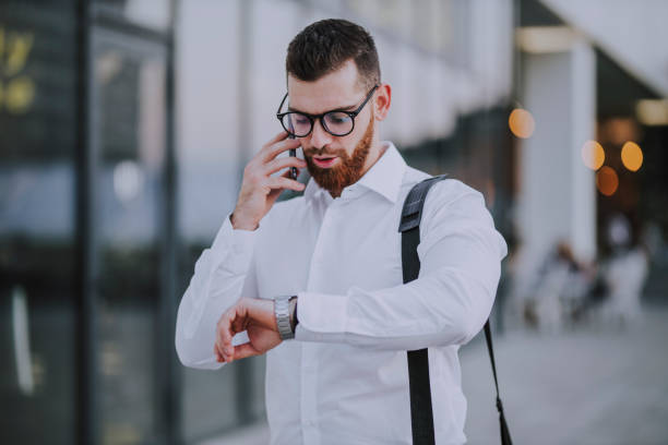 istock Businessman looking at wristwatch 1183746129