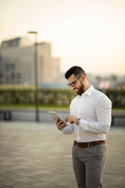 istock Businessman with digital tablet in public park 1183746434