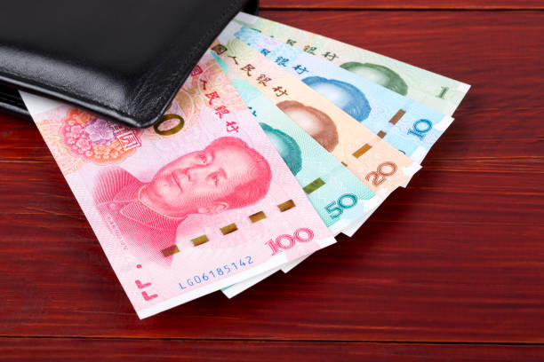 istock Chinese Yuan on a wooden background 1183749045