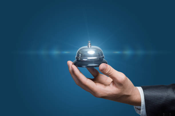 The hand shows a bell on a blue background.