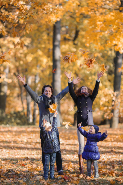 istock Family playing in autumn park 1183750531