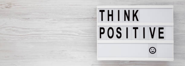 istock 'Think positive' words on a modern board on a white wooden background, top view. Overhead, from above, flat lay. Copy space. 1183750749