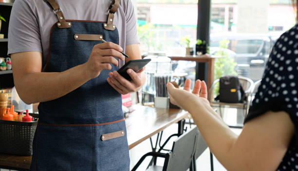 istock Employee holding a smartphone to save the menu the customer order. 1183751509