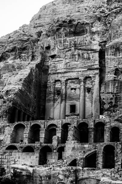 Antique man and camel sculptures carved in sandstone wall of Siq passage in Petra, Jordan.