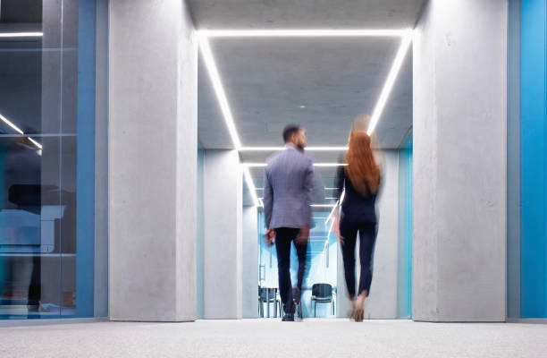 istock Business People Walking Across the Corridor 1183759271