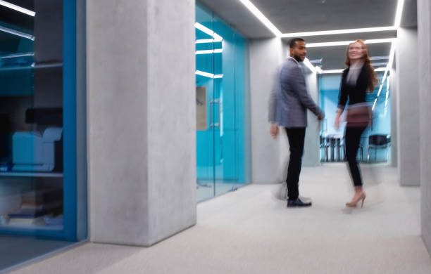 istock Business People Walking Across the Corridor 1183759319