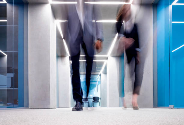 istock Business People Walking Across the Corridor 1183759481