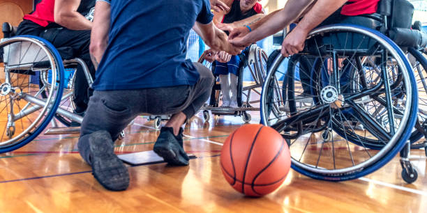 istock Disabled basketball players clasping hands with coach 1183759621