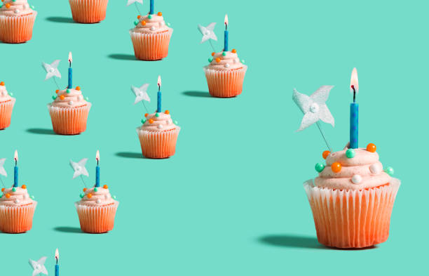istock Big and small cupcakes with lit candles 1183761521