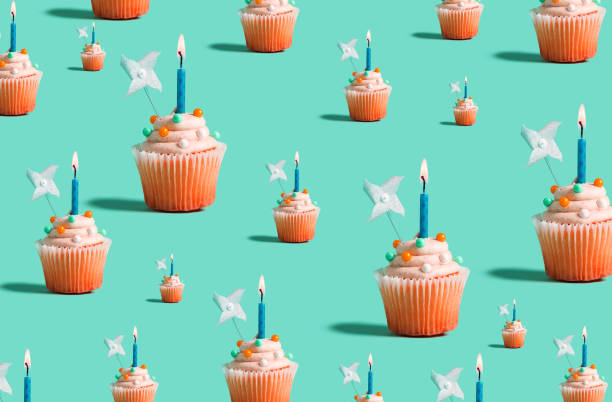 istock Big and small cupcakes with lit candles 1183761526