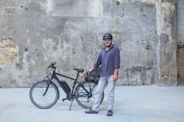 istock man standing in front of electric bicycle 1183762841