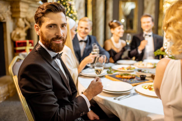 istock Man with friends during a festive dinner on New Years Eve 1183763321