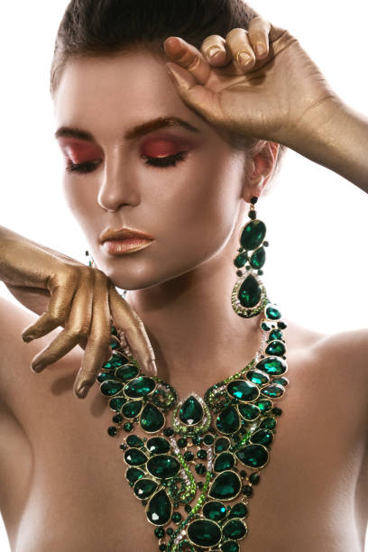 Gorgeous woman is wearing big beautiful necklace with a lot of gems