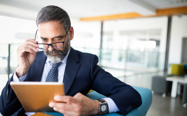 istock Confident senior businessman leader working in office 1183764789